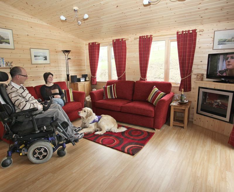 With all the comforts of home and a wide range of specialist equipment you can relax in our peaceful surroundings and take time out to watch the wildlife. For the more adventurous why not hire the Boma 7 off-road wheelchair to explore local trails?

Sleeping up to four guests each lodge has an accessible wheel in shower room and a luxurious family bathroom. There is plenty of space for wheelchair users, and the log cabins are dog friendly with some wonderful walks from the door. 

Owners David and Felicity Brown live on site and are on hand to help.