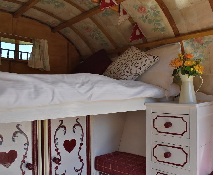 Rose Hip Gypsy Caravan is an idyllic, romantic hideaway just for two; relax and cook by the firepit under the stars. Under the traditional bow top canvas there is a slide out double bed to climb into, bench seating and storage cupboards. 

Steeped in history our gorgeous gypsy caravan takes glamping to the next level with modern additions, including 12volt lighting, USB charging and WiFi. Bedding and towels included and a modern shower room just a few yards away.