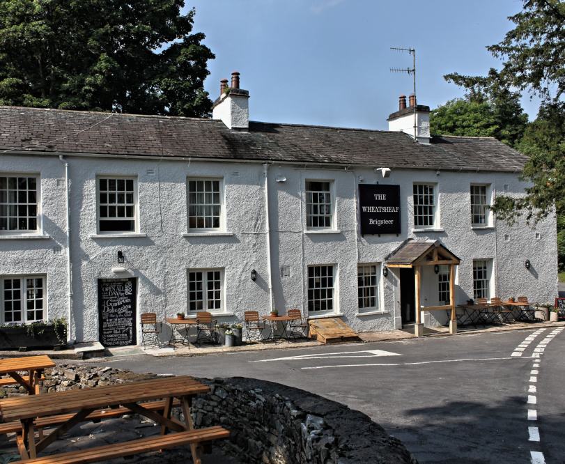 Based in the beautiful village of Brigsteer in the Lake District National Park, the multi award-winning Wheatsheaf Inn is perfect for families, walkers, cyclists and dog owners.

At the foot of the peak of Scout Scar and surrounded by beautiful views across the Lyth Valley, this historic inn (dating back to 1762) has six cosy bedrooms and serves real ale and home-cooked food.

[symple_column size=