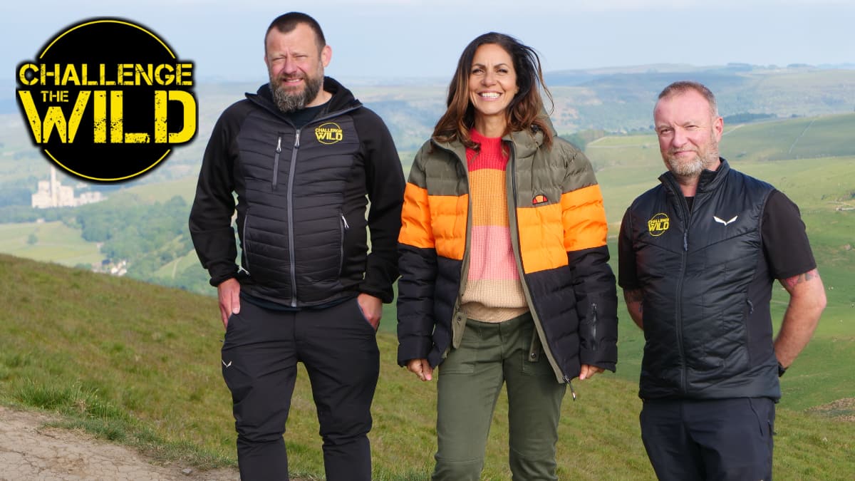 This is a picture of Julia Bradbury and the team at Challenge The Wild. A beautiful backdrop of the peaks.