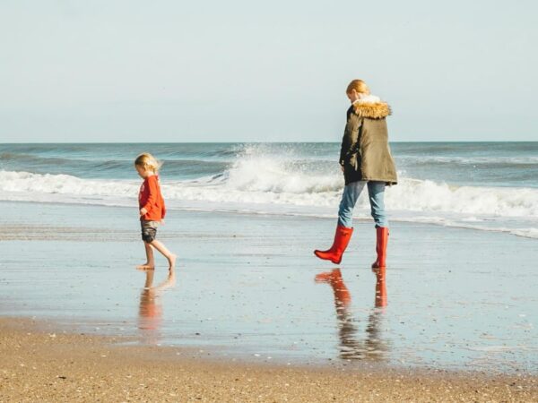 Family Coastal Walks Julia Bradbury Coastal walking father and son on the beach South West Coastal Path.