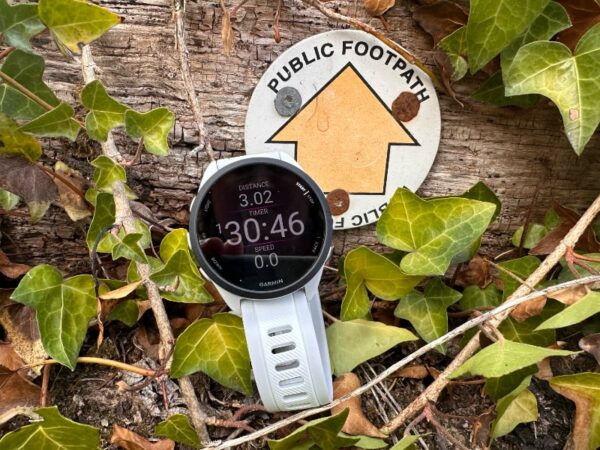 Garmin Smart Watch resting against a pile of leaves on a review walk.